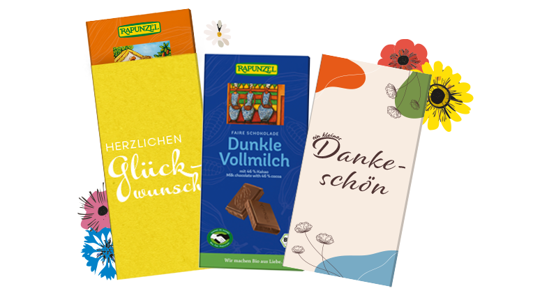 Drei bunte Schokoladenverpackungen von Rapunzel mit den Aufschriften 'Herzlichen Glückwunsch', 'Dunkle Vollmilch' und 'Danke schön', umgeben von bunten Blumenillustrationen