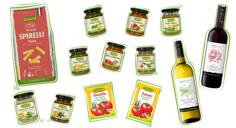 Verschiedene mediterrane Rapunzel Produkte frei arrangiert: Pesto, Spirelli-Nudeln, Passata, getrocknete Tomaten und Bio-Weine – in hochwertiger Bio-Qualität und stimmiger Farbkompositio
